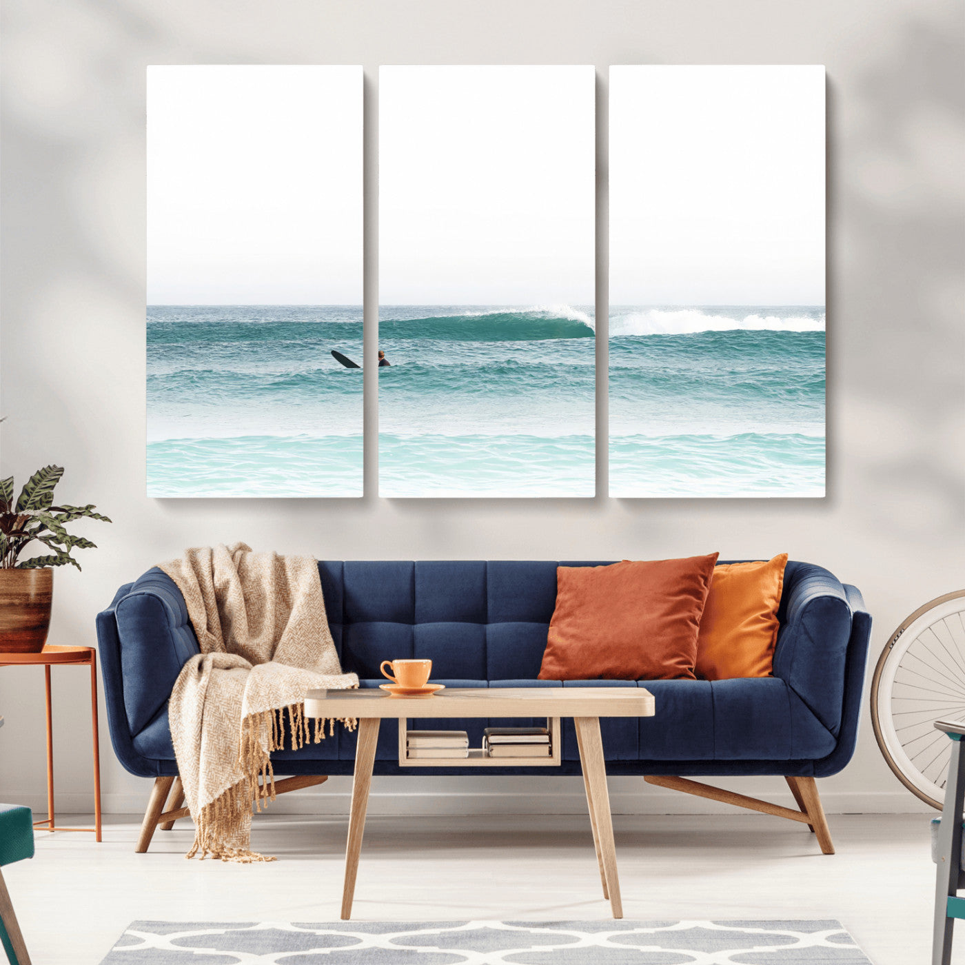 Minimalist photo of a lone surfer on calm aqua waves under bright sky, perfect for Scandinavian coastal or serene ocean-inspired home decor.