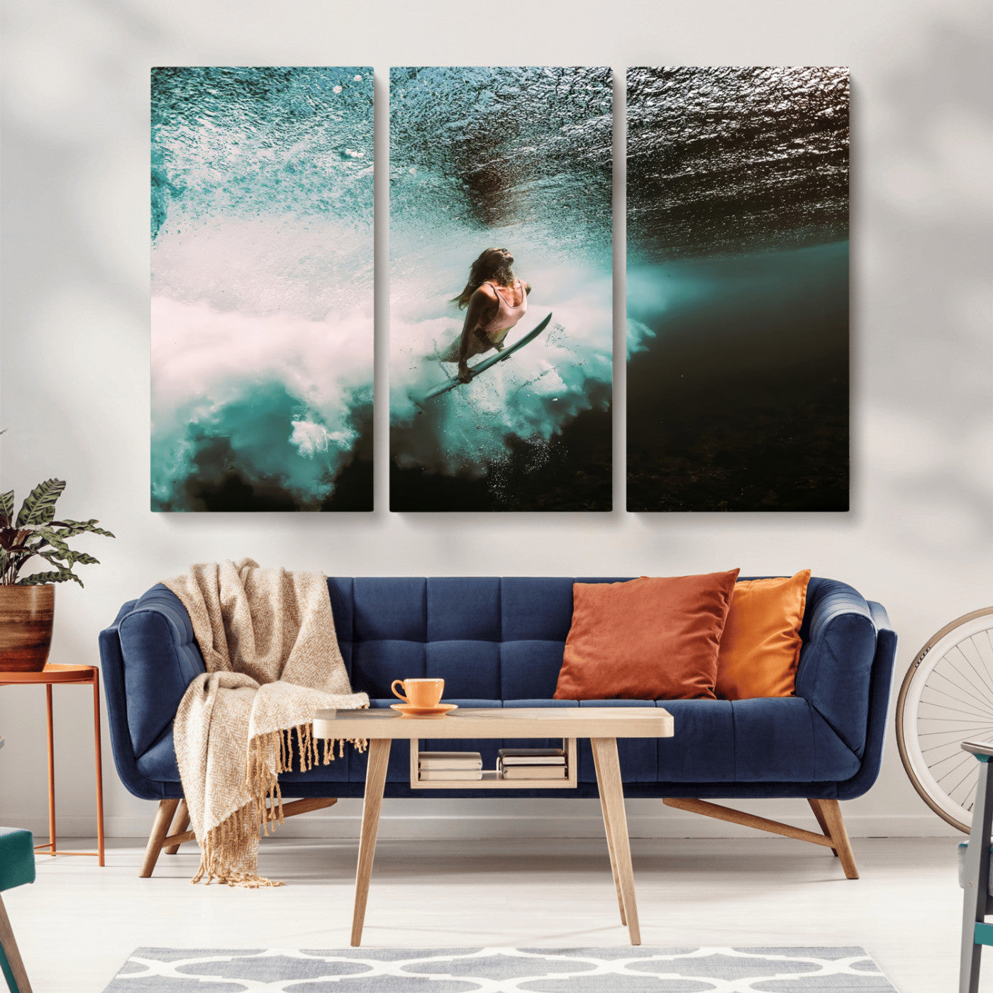 Vibrant underwater photo of a female surfer diving through turquoise waves, perfect for coastal boho or surf-inspired home decor.