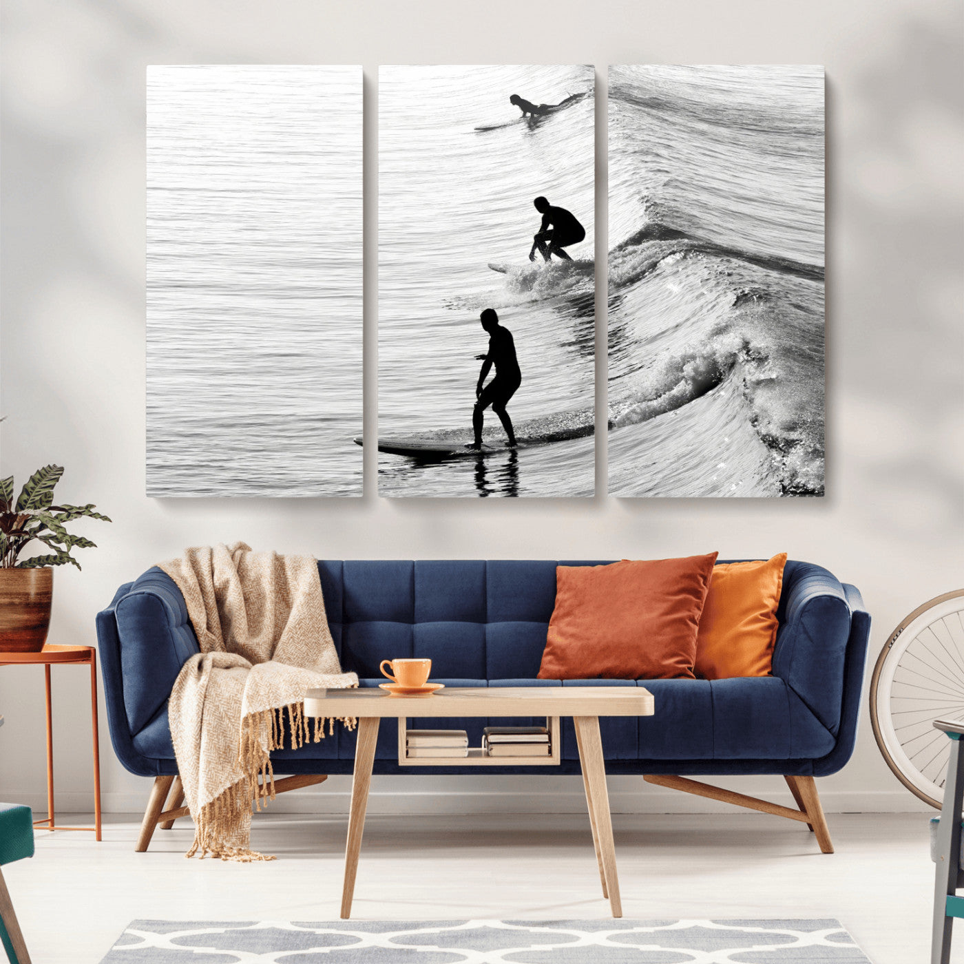 Black and white photo of surfers riding waves in a moody, high-contrast scene, ideal for modern coastal or surf-inspired home decor.
