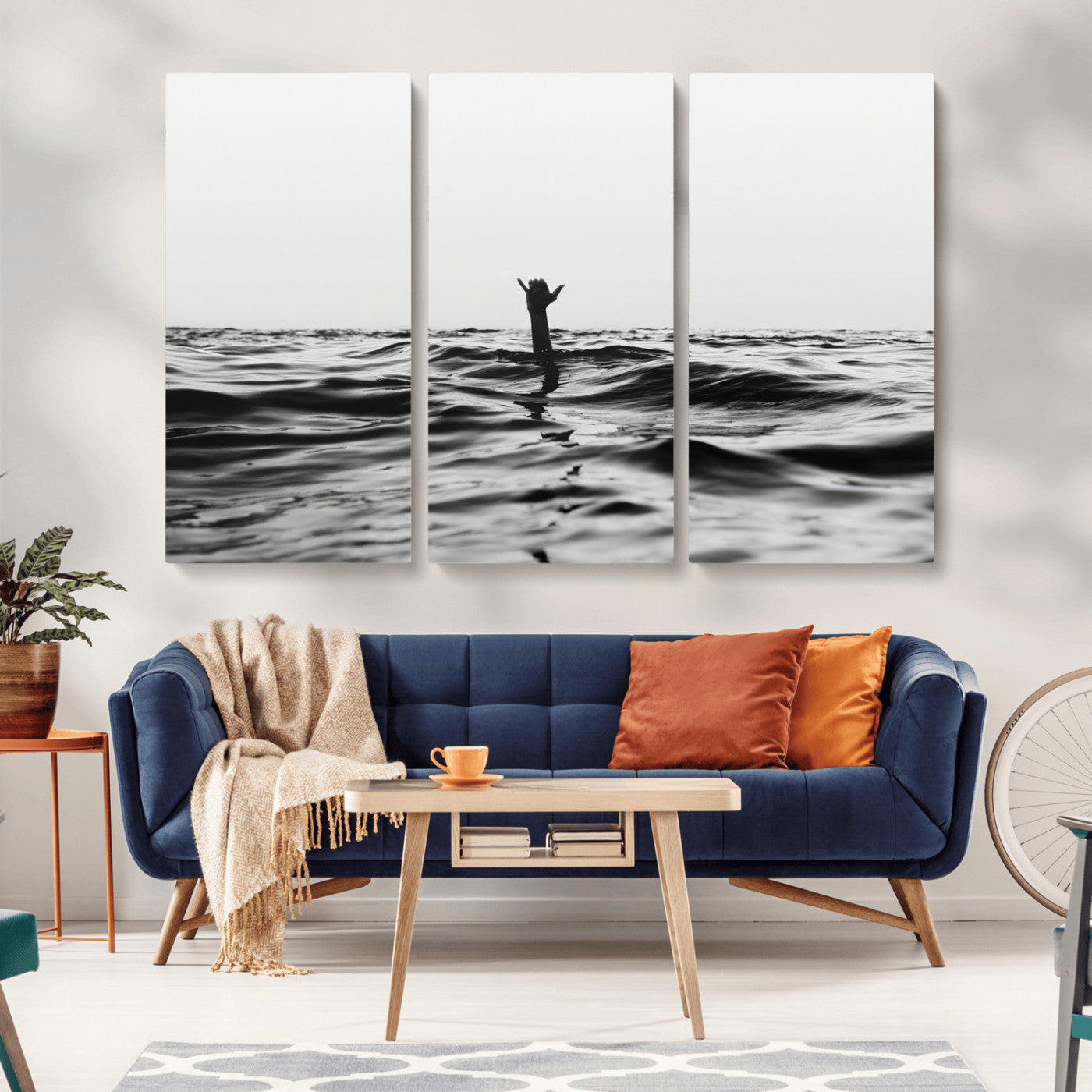 Black and white ocean with a hand making a surfer sign among dark waves, creating a dramatic and minimalist seascape with bold contrast.