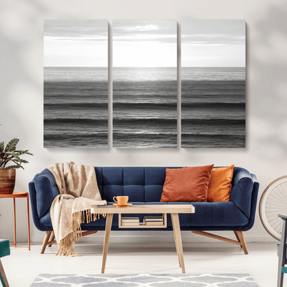 Minimalist black and white ocean view with layered waves reflecting sunlight, evoking a sense of calm and coastal serenity.