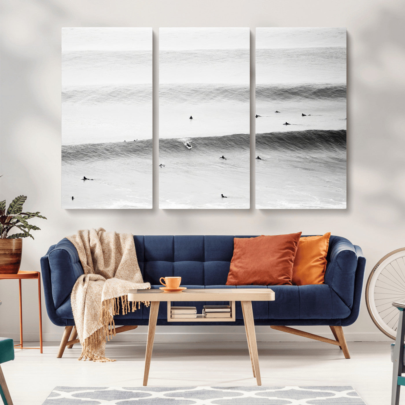 A monochrome photograph of swimmers gliding through gentle ocean waves, evoking a sense of calm and movement.