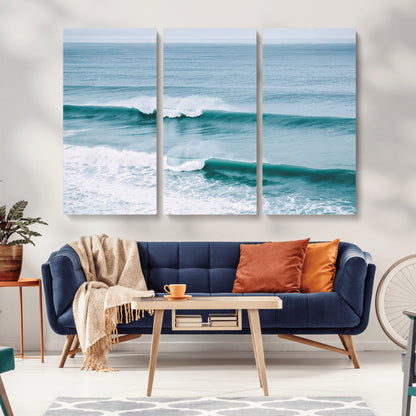 Powerful ocean waves rolling towards the shore, their turquoise hues blending with white sea foam under an open horizon, capturing the essence of the ocean's movement.