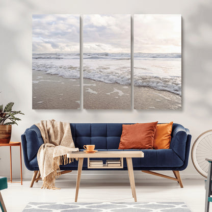 Peaceful ocean waves rolling onto the sandy shore under soft light, perfect for neutral or coastal minimalist decor themes.