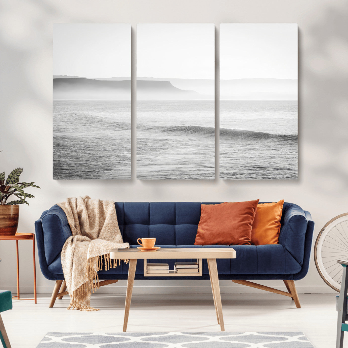 A black and white minimalist seascape featuring soft rolling waves and misty distant cliffs, creating a serene and timeless coastal atmosphere.