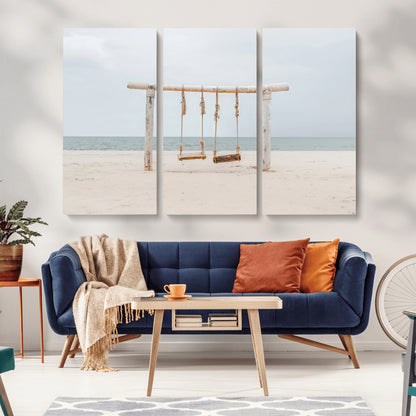 A rustic wooden beach swing stands on a serene sandy shore with an ocean horizon in the background, creating a tranquil and dreamy coastal escape.