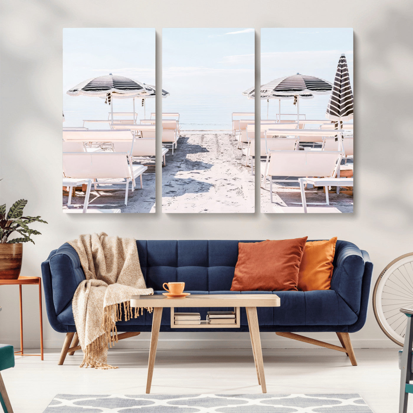 A serene minimalist beach scene featuring striped umbrellas, soft pastel sand, and an elegant lounge setup, creating a tranquil and stylish coastal retreat.