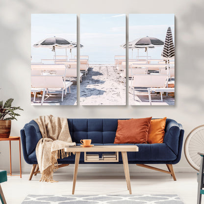 A serene minimalist beach scene featuring striped umbrellas, soft pastel sand, and an elegant lounge setup, creating a tranquil and stylish coastal retreat.