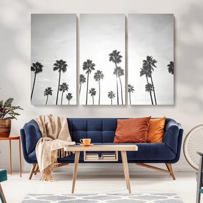 A black and white minimalist scene featuring tall palm trees silhouetted against a bright sky, creating a dreamy and timeless tropical aesthetic.