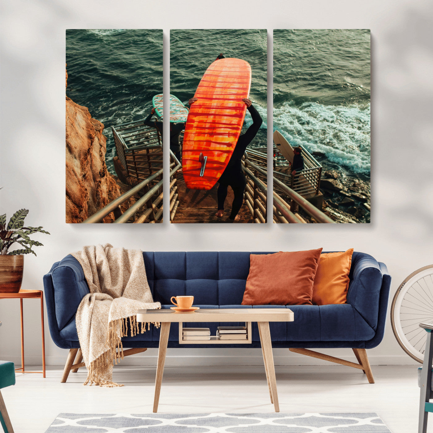 A surfer carrying a bold orange surfboard down a rugged staircase toward the ocean, bathed in golden hour light, capturing the energy of coastal adventure.