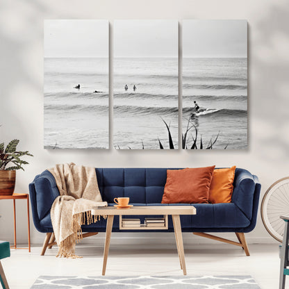 Monochrome canvas of surfers on calm ocean waves, ideal for minimalist coastal or beach-inspired interior decor.