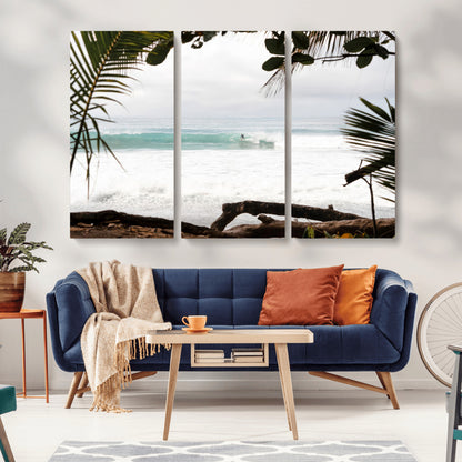 Tropical beach view with palm trees and surfer riding a wave, perfect for boho or coastal-inspired interior wall decor.