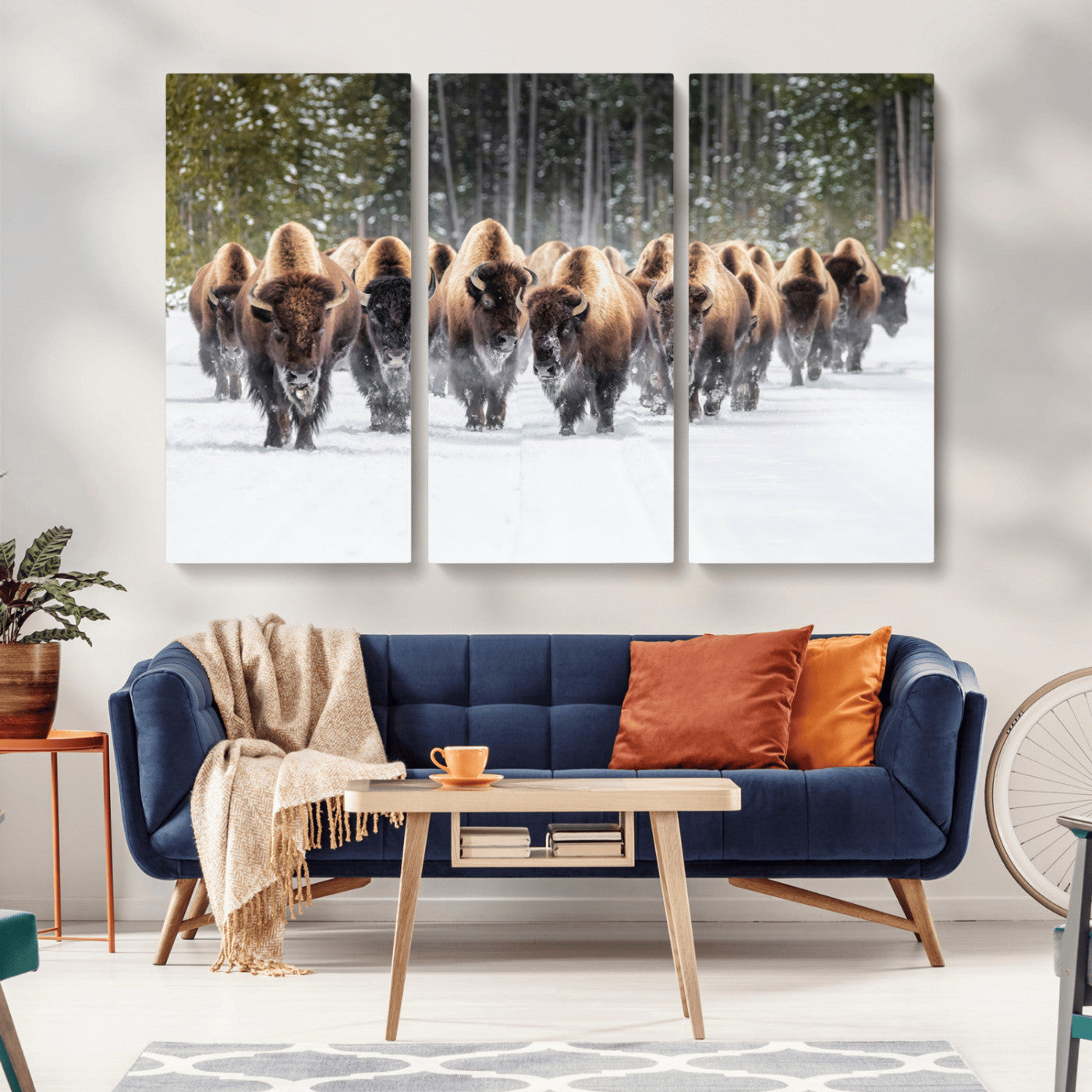 A herd of American bisons walking through a snowy forest path, perfect for rustic cabin or Western-themed wall decor.