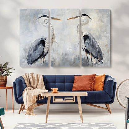 Two herons facing each other on a soft-toned background with blue-grey feathers, perfect for tranquil, coastal or nature-themed interiors.