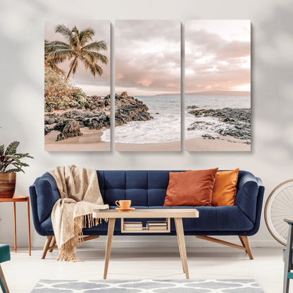 A peaceful beach scene with a palm tree and rocks, soft waves washing onto the shore under a soft pastel sky at sunset.