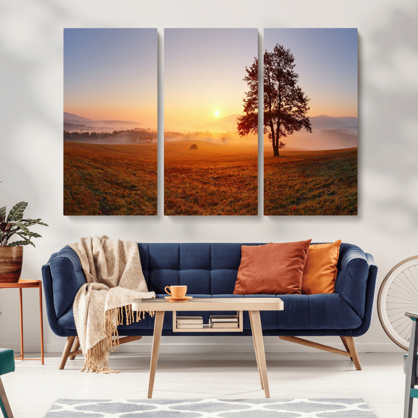 A tranquil landscape at sunrise with a mist-covered field and a lone tree, creating a peaceful and natural atmosphere.
