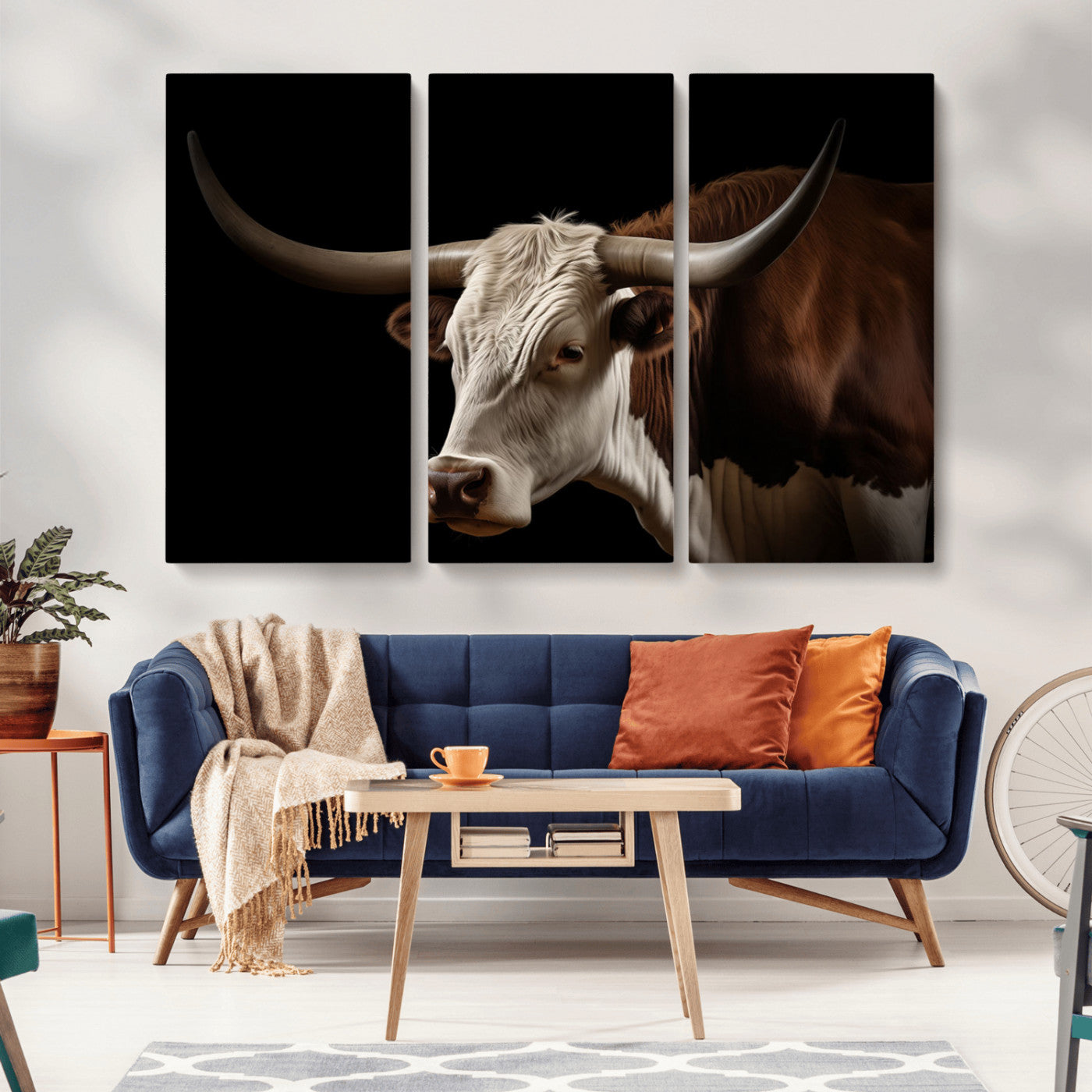 "Close-up of a brown and white longhorn cow with prominent curved horns against a black background."