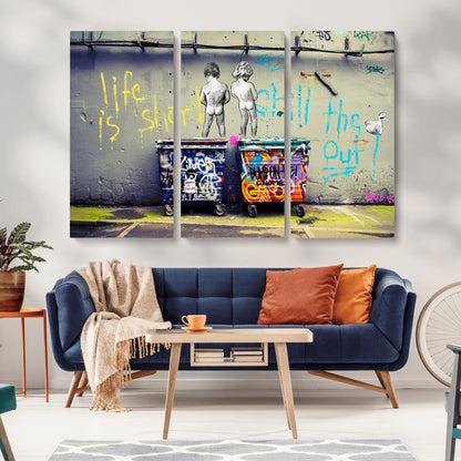 Graffiti-style canvas art with bold text and two naked figures over urban dumpsters, ideal for edgy or street-style decor.