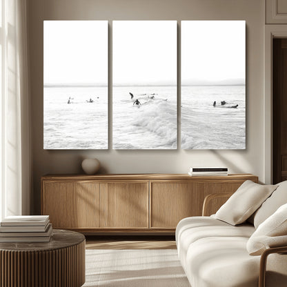 Monochrome photo of surfers riding and waiting on ocean waves, ideal for surf-themed or coastal energy wall decor.