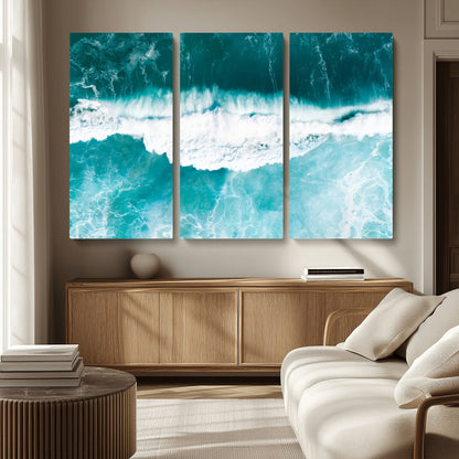 Aerial view of turquoise ocean waves crashing with white foam, perfect for tropical coastal or modern beach-style home decor.