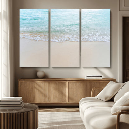 Soft shoreline with gentle aqua waves on smooth sand, ideal for minimalist coastal or pastel ocean-inspired home wall decor.