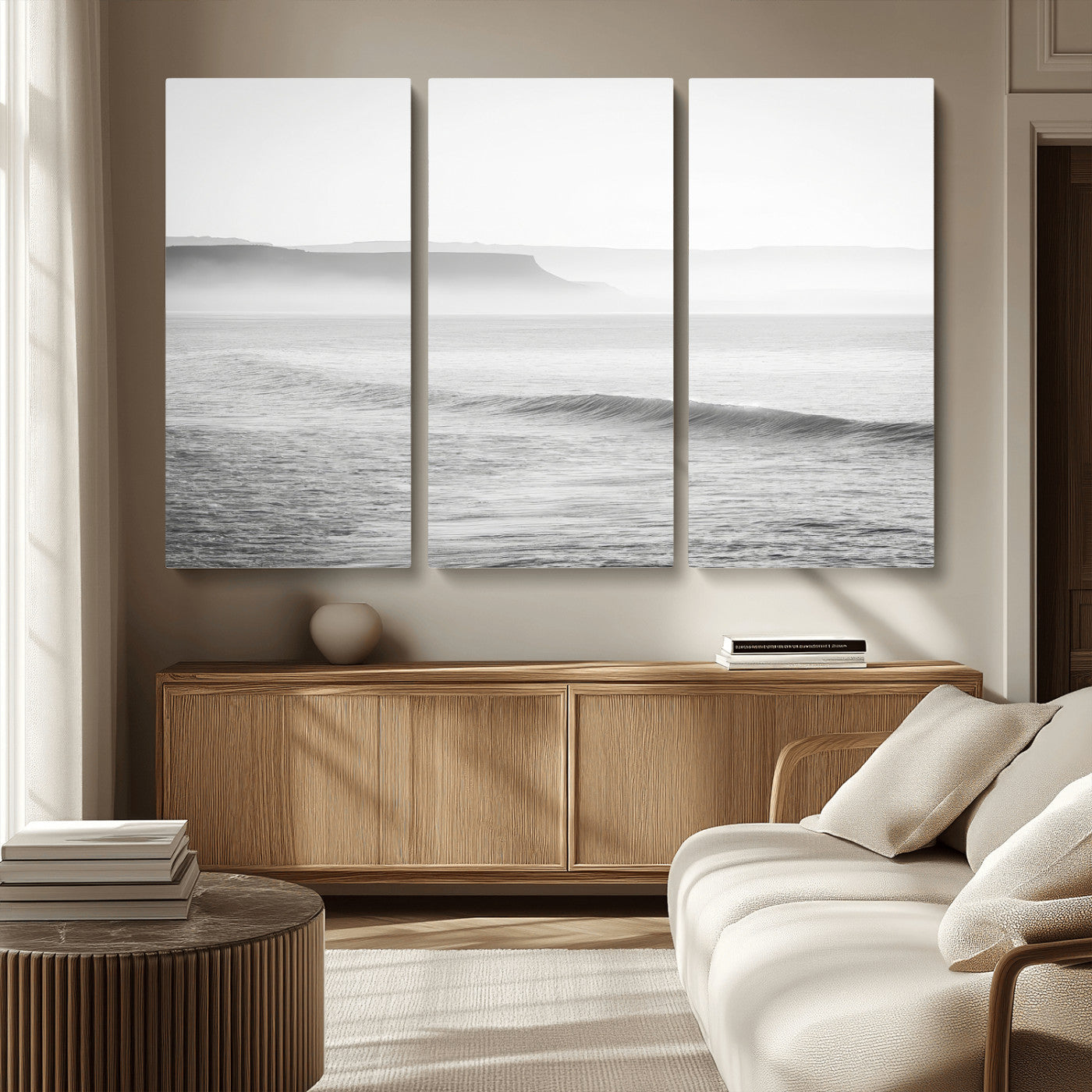 A black and white minimalist seascape featuring soft rolling waves and misty distant cliffs, creating a serene and timeless coastal atmosphere.