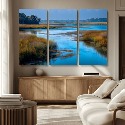 A peaceful marshland scene with calm blue water reflecting the surrounding grasses and trees, capturing the beauty of nature in a serene landscape.