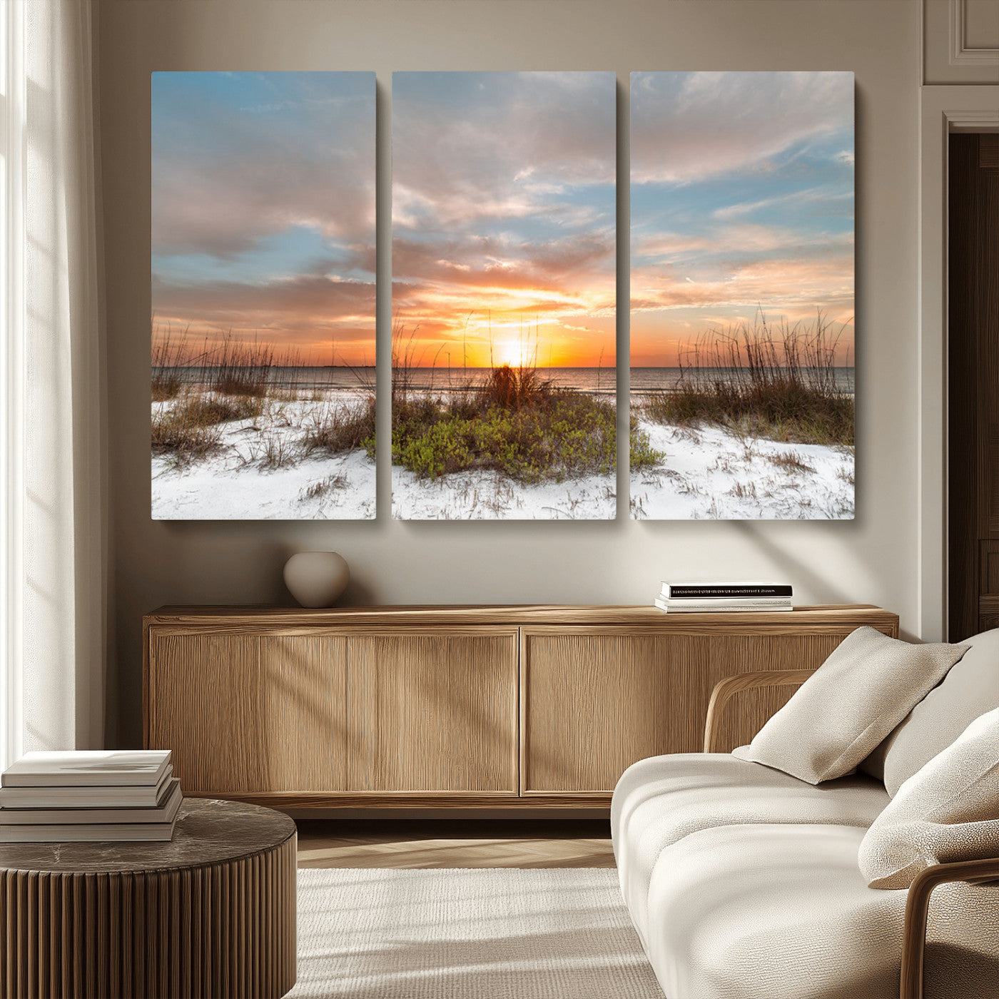 A tranquil beach scene featuring golden sunset hues over the water, with grasses in the foreground and a peaceful, serene atmosphere.