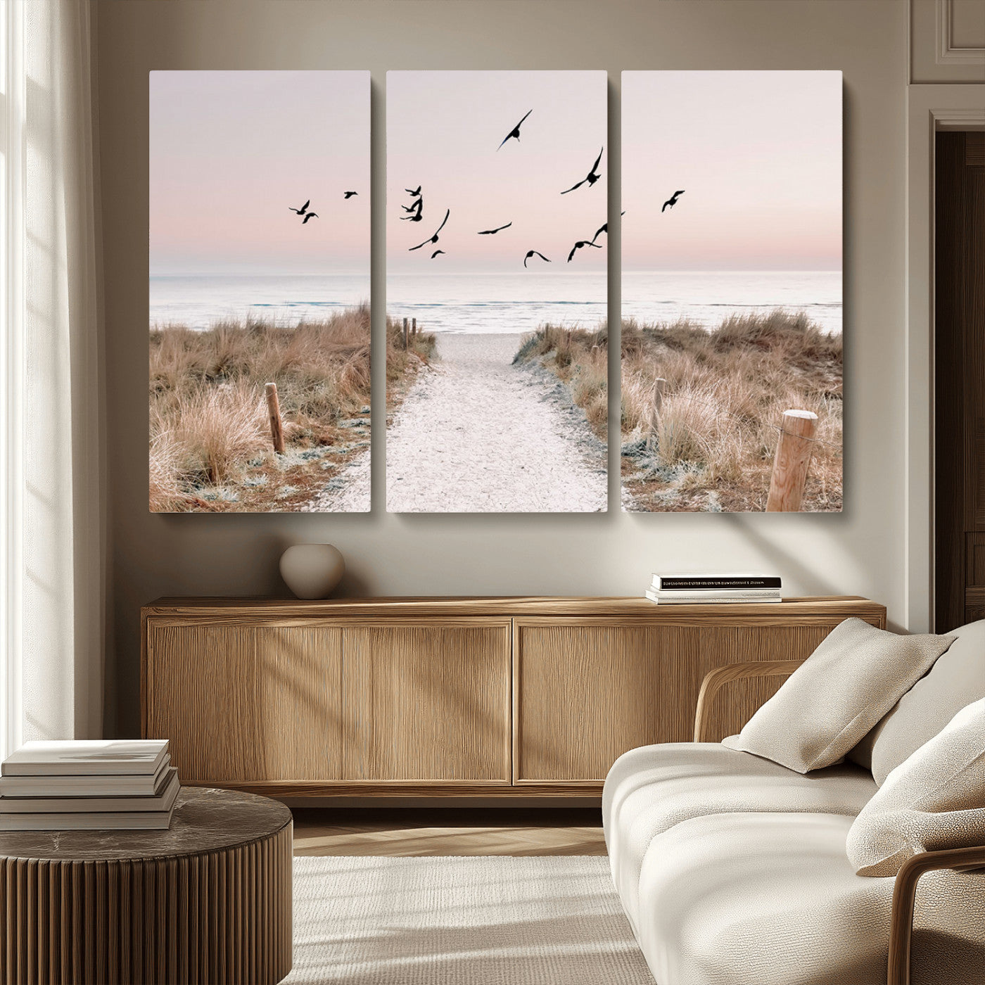 A peaceful coastal pathway leading to the ocean, with birds flying across a soft pastel sky, creating a calm and scenic beach atmosphere.
