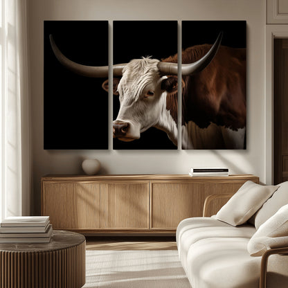 "Close-up of a brown and white longhorn cow with prominent curved horns against a black background."