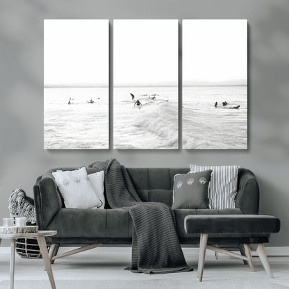 Monochrome photo of surfers riding and waiting on ocean waves, ideal for surf-themed or coastal energy wall decor.