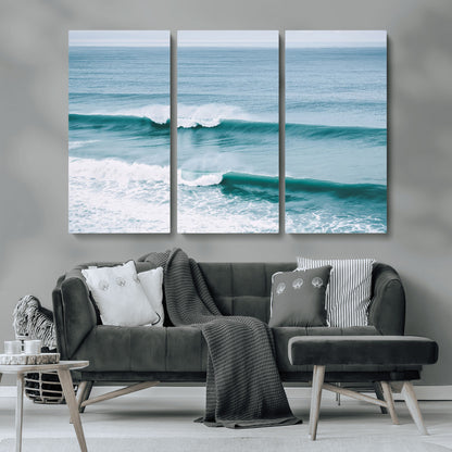 Powerful ocean waves rolling towards the shore, their turquoise hues blending with white sea foam under an open horizon, capturing the essence of the ocean's movement.