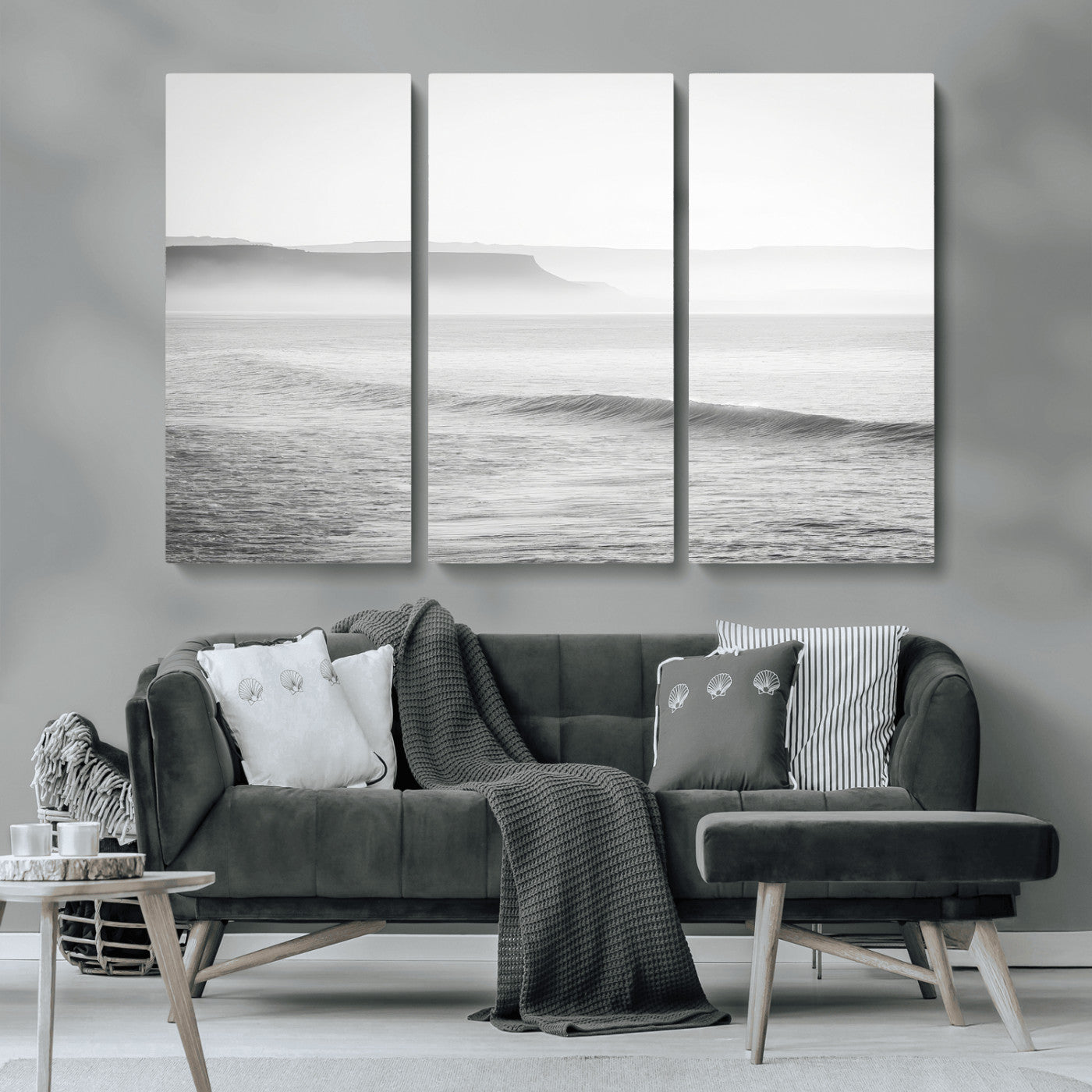 A black and white minimalist seascape featuring soft rolling waves and misty distant cliffs, creating a serene and timeless coastal atmosphere.
