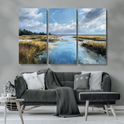 A beautiful, painterly landscape of a calm river winding through a marsh, with vibrant green grasses and a bright blue sky filled with fluffy clouds.