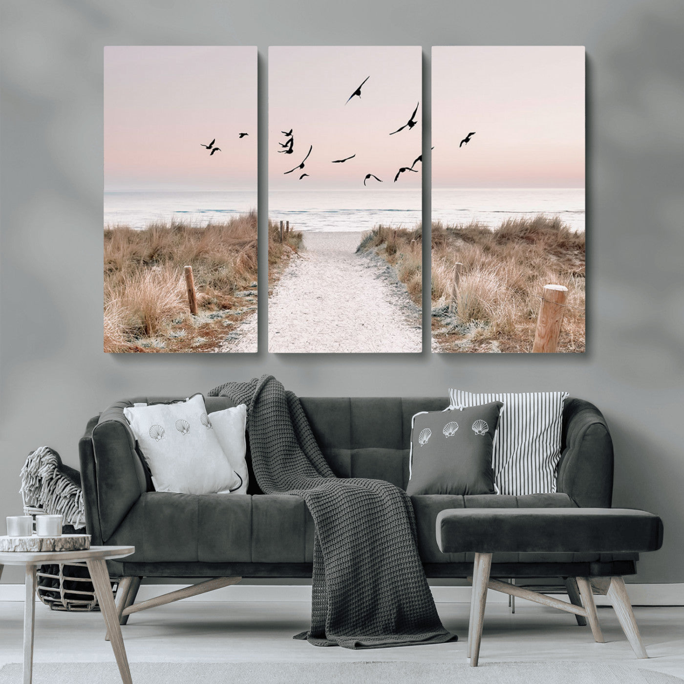 A peaceful coastal pathway leading to the ocean, with birds flying across a soft pastel sky, creating a calm and scenic beach atmosphere.