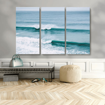 Powerful ocean waves rolling towards the shore, their turquoise hues blending with white sea foam under an open horizon, capturing the essence of the ocean's movement.