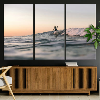 Framed canvas of a female surfer balancing on a wave at sunset, perfect for serene surf or ocean-inspired coastal decor.
