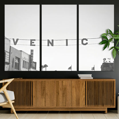 Black and white photo of Venice Beach sign and palm-lined street, perfect for urban coastal or minimalist LA-inspired wall decoration.