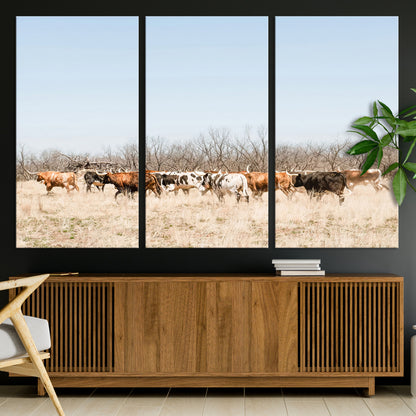 Framed wall art of Texas longhorn cattle walking through a dry, neutral-toned prairie, perfect for rustic farmhouse or western-themed home decor.