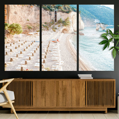 Wall art of a calm Mediterranean beach with rows of sun loungers and umbrellas in soft pastel tones, perfect for light coastal or vacation-themed decor.