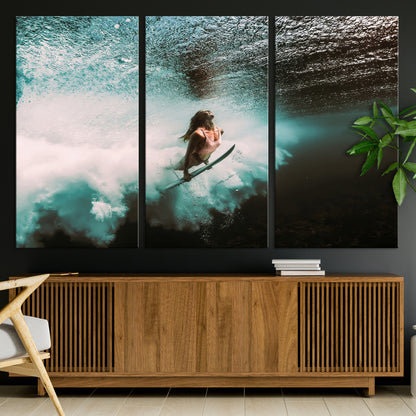 Vibrant underwater photo of a female surfer diving through turquoise waves, perfect for coastal boho or surf-inspired home decor.