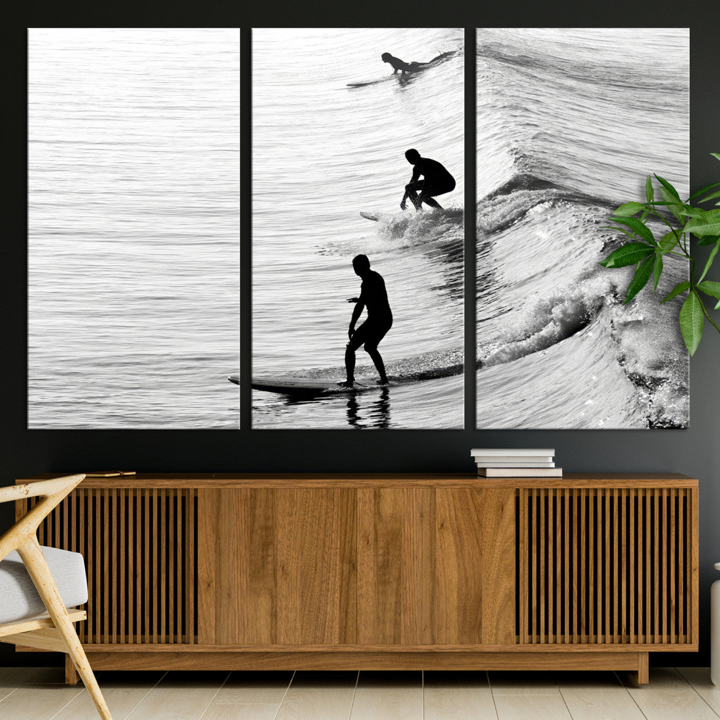 Black and white photo of surfers riding waves in a moody, high-contrast scene, ideal for modern coastal or surf-inspired home decor.