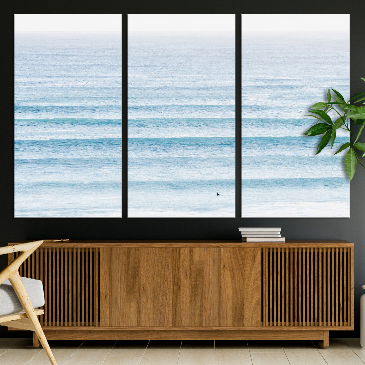Minimalist ocean view with soft blue waves and a lone surfer, creating a serene and airy coastal aesthetic, perfect for tranquil home decor.
