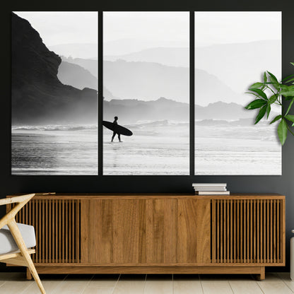 A lone surfer walking along a misty beach with cliffs in the background, carrying their board, capturing a serene and minimal ocean moment.