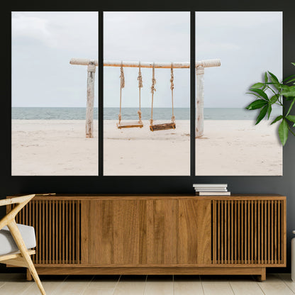 A rustic wooden beach swing stands on a serene sandy shore with an ocean horizon in the background, creating a tranquil and dreamy coastal escape.