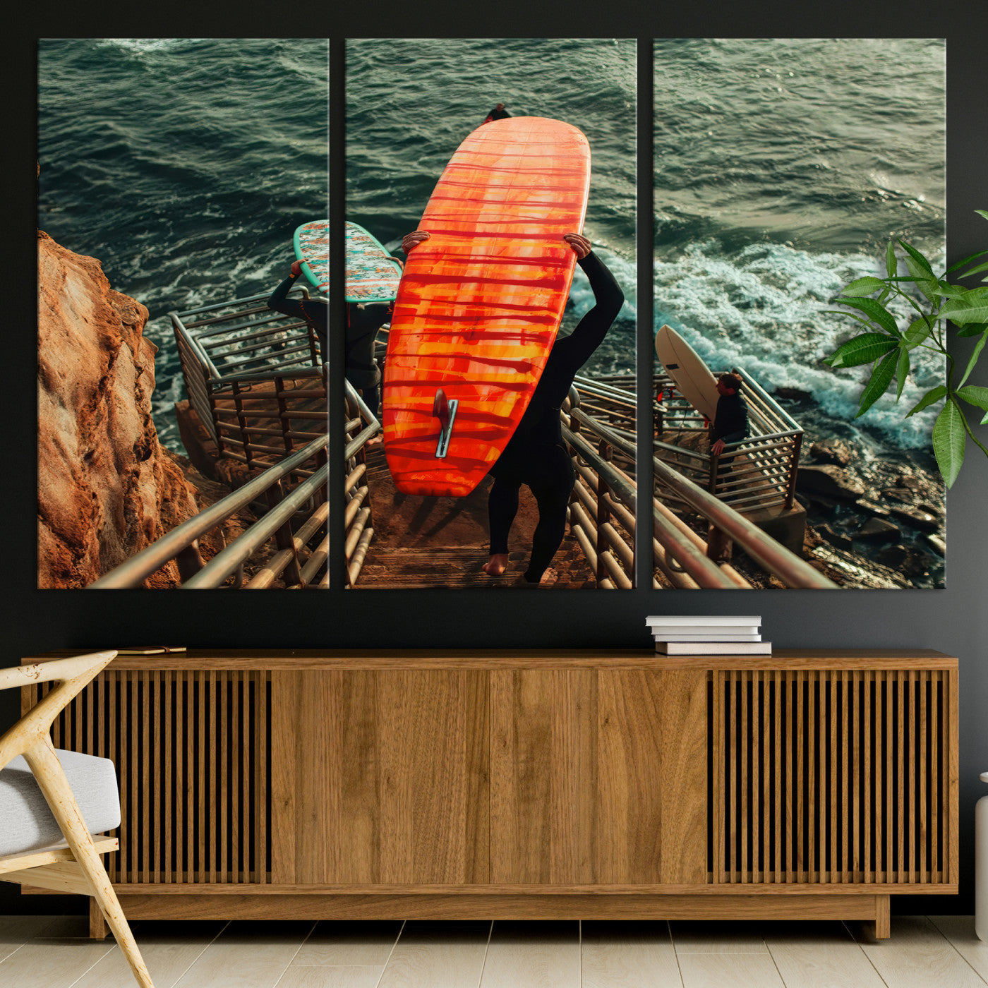 A surfer carrying a bold orange surfboard down a rugged staircase toward the ocean, bathed in golden hour light, capturing the energy of coastal adventure.