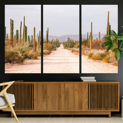 A desert road lined with saguaro cacti under a golden sky, creating a warm southwestern feel, perfect for boho or rustic decor.