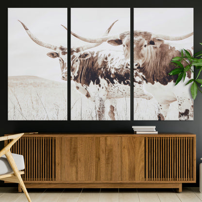 Two longhorn cows standing in a sepia-toned pasture with soft light, ideal for rustic or farmhouse-themed neutral wall decor.