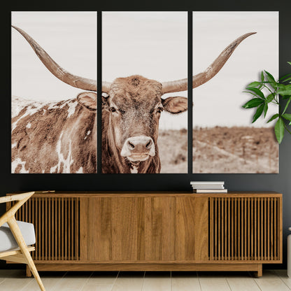A longhorn cow in soft beige desert tones, standing calmly in open land, perfect for neutral western or rustic farmhouse interiors.