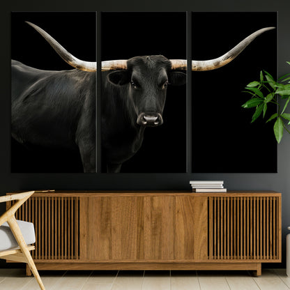 Close-up of a black Texas longhorn with large curved horns on black background, ideal for rustic farmhouse or modern western interiors.